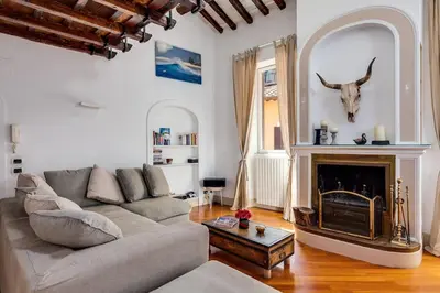 a living room with a couch and a fireplace at Che Eleganza! Irresistibile dimora, Campo de Fiori in Rome