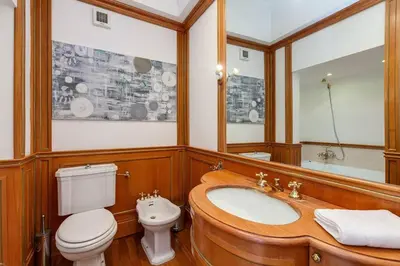a bathroom with a toilet and a sink and a mirror at Che Eleganza! Irresistibile dimora, Campo de Fiori in Rome