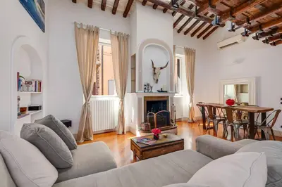 a living room with a couch and a table at Che Eleganza! Irresistibile dimora, Campo de Fiori in Rome
