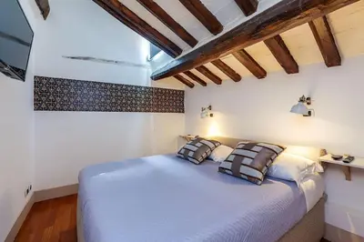 a bedroom with a large bed with two pillows at Che Eleganza! Irresistibile dimora, Campo de Fiori in Rome