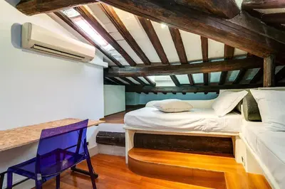a small bedroom with a bed and a desk at Che Eleganza! Irresistibile dimora, Campo de Fiori in Rome
