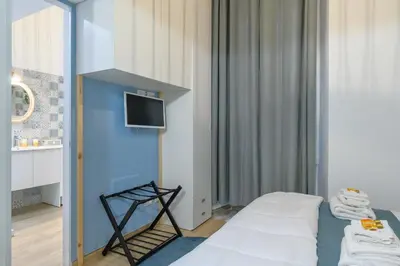 a room with a bed and a tv on a wall at Appartamento via Visconti in Rome