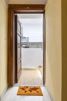 an open door into a room with a rug on the floor at Appartamento via Visconti in Rome