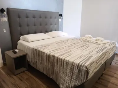 a bedroom with a large bed with a large headboard at ANGI HOME in Rome