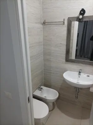 a bathroom with a sink and a toilet and a mirror at ANGI HOME in Rome