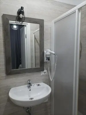 a bathroom with a sink and a mirror at ANGI HOME in Rome