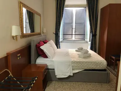 a hotel room with a bed with towels on it at A ROSMINI SUITES in Rome