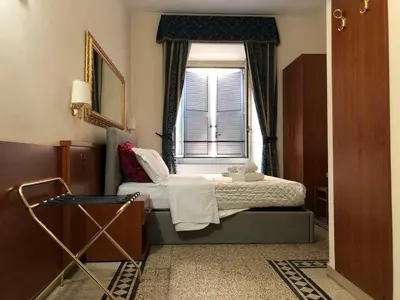 a bedroom with a bed and a window at A ROSMINI SUITES in Rome