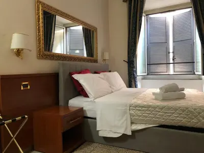 a hotel room with a bed and a mirror at A ROSMINI SUITES in Rome