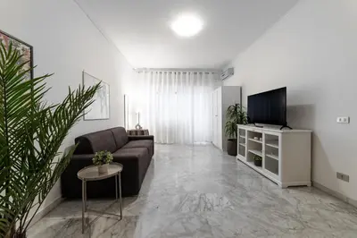 a living room with a couch and a tv at EV Vatican Apartment in Rome