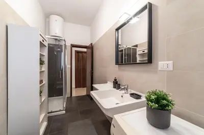 a bathroom with a sink and a mirror at EV Vatican Apartment in Rome
