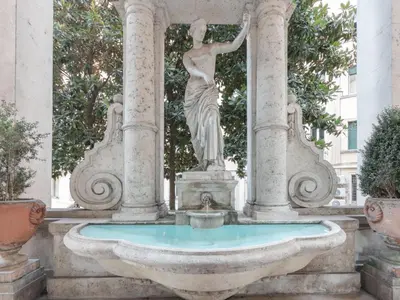 a statue of a woman in a fountain at Studio Le Belle Arti by Interhome in Rome
