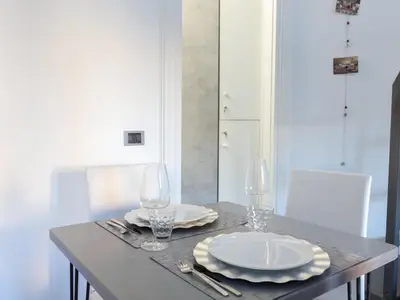 a table with two plates and wine glasses on it at Studio Le Belle Arti by Interhome in Rome