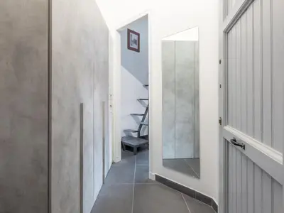 a hallway with a mirror and a staircase at Studio Le Belle Arti by Interhome in Rome