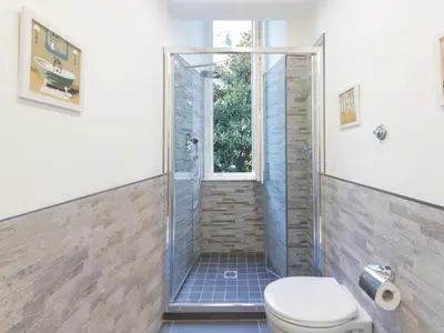 a bathroom with a shower with a toilet and a window at Studio Le Belle Arti by Interhome in Rome