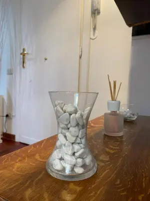 a vase filled with rocks sitting on a table at Edi's House in Rome
