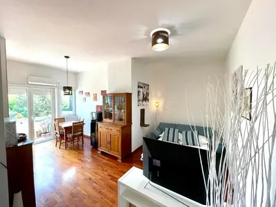 a living room with a television and a dining room at Edi's House in Rome
