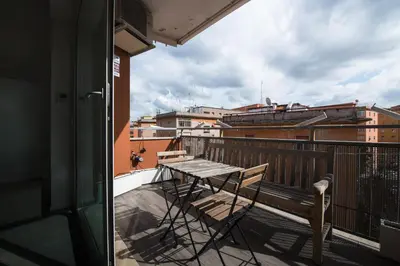 a balcony with a table and a bench on a balcony at Time 4 Rome in Rome