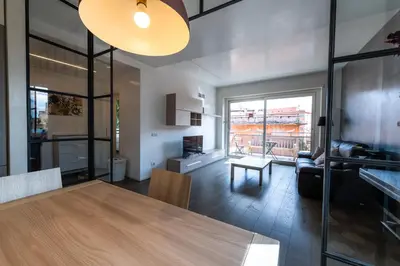 a kitchen and living room with a table and a couch at Time 4 Rome in Rome