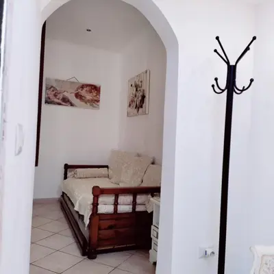 a bedroom with a bed in a white wall at Appartamento Eleonora in Rome