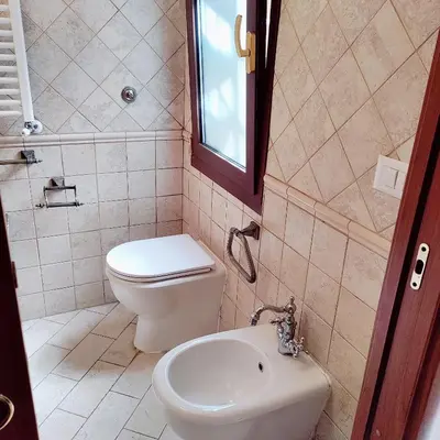 a bathroom with a toilet and a sink at Appartamento Eleonora in Rome