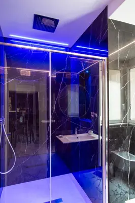 a bathroom with a glass shower and a sink at Romantic Suite Colosseum - Luxury Apartment in Rome