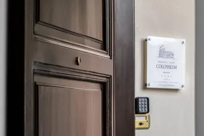 a door with a sign on it with a door knob at Romantic Suite Colosseum - Luxury Apartment in Rome
