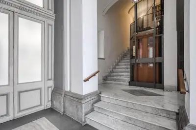 a hallway with stairs and a door in a building at Romantic Suite Colosseum - Luxury Apartment in Rome