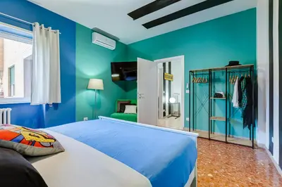 a blue bedroom with a bed and blue walls at BDC - The Perfect Mix in Rome