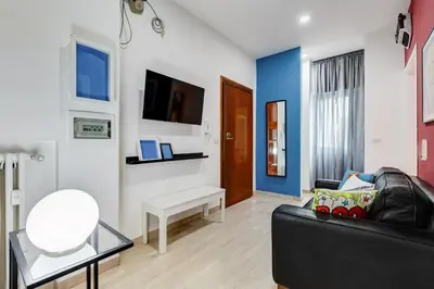 a living room with a black couch and a tv at BDC - The Perfect Mix in Rome