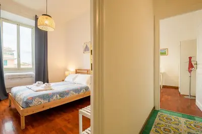 a bedroom with a bed and a window at Candia Cento Apartment Vatican Museums in Rome