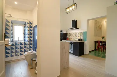 a bathroom with a sink and a toilet in a room at Candia Cento Apartment Vatican Museums in Rome