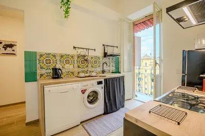 a kitchen with a washing machine in a kitchen at Candia Cento Apartment Vatican Museums in Rome