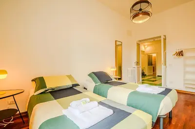 two beds sitting next to each other in a room at Candia Cento Apartment Vatican Museums in Rome