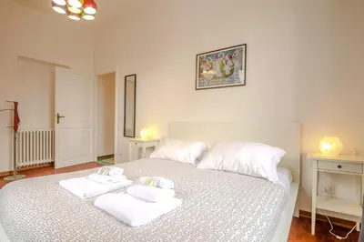 a bedroom with a white bed with towels on it at Candia Cento Apartment Vatican Museums in Rome