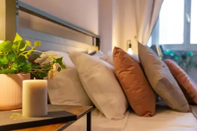 a group of pillows on a couch with a table at Piacentino Homes Re di Roma apartment in Rome