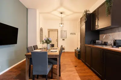 a kitchen with a wooden table and chairs in a kitchen at Piacentino Homes Re di Roma apartment in Rome
