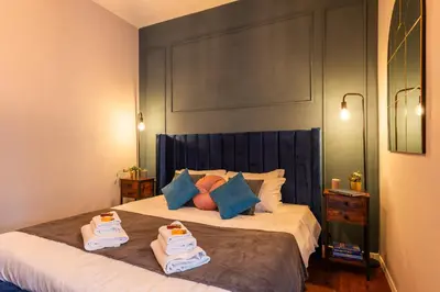a bedroom with a bed with two towels on it at Piacentino Homes Re di Roma apartment in Rome