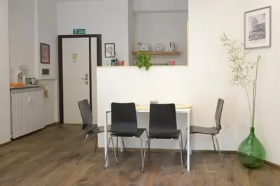 a dining room with a table and black chairs at Vatican Garden Oasi in Rome
