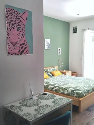 a bedroom with a bed and a painting of a leopard at Vatican Garden Oasi in Rome