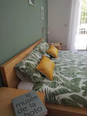 a bed with yellow pillows and a sign on it at Vatican Garden Oasi in Rome
