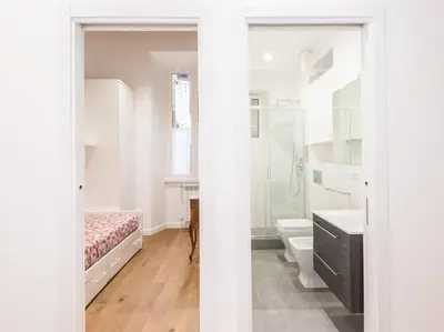 a white bathroom with a bed and a sink at Trastevere Luxury Bright Apartment in Rome