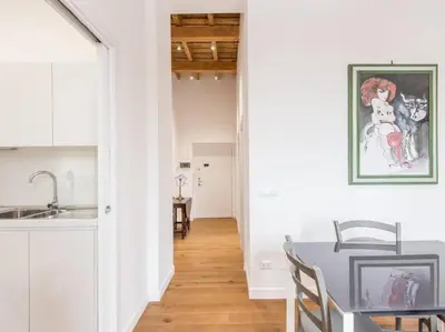 a kitchen and a dining room with a table at Trastevere Luxury Bright Apartment in Rome
