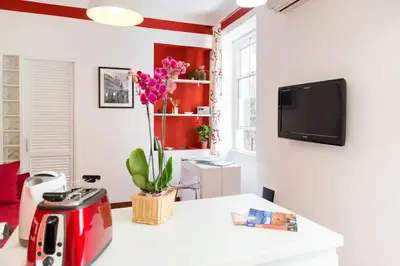 a living room with a table and a tv at Perla - Cozy Apartment in Piazza Navona in Rome