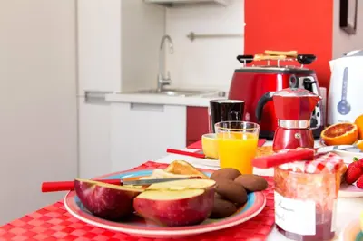 a table with a plate of food and fruit on it at Perla - Cozy Apartment in Piazza Navona in Rome
