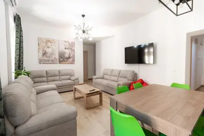 a living room with a table and a couch at Trastevere four seasons Feltre in Rome