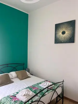 a bedroom with a bed and a picture on the wall at Trastevere four seasons Feltre in Rome