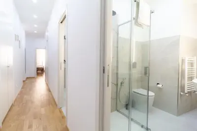 a bathroom with a glass shower and a toilet at Trastevere four seasons Feltre in Rome