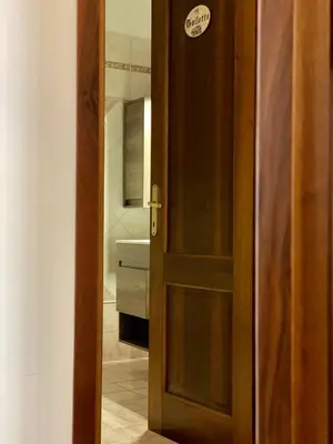 an open door to a bathroom with a sink at MM Ma Maison in Rome