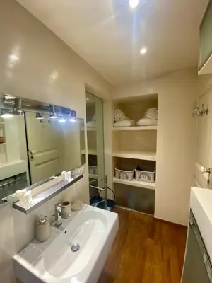 a bathroom with a white sink and a mirror at 78 Luxury Margutta Suite in Rome